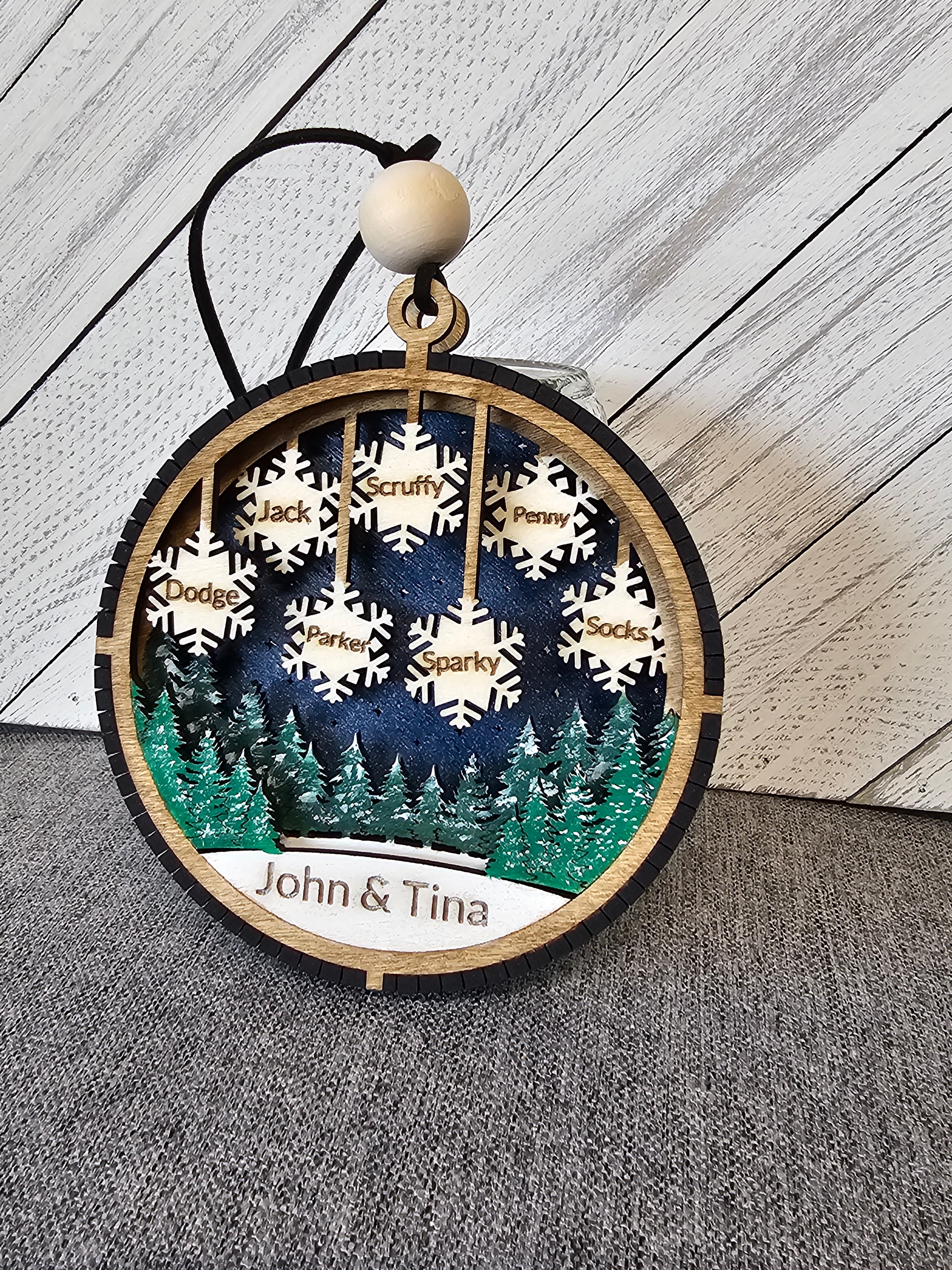 Personalized Lighted Snowflake Family Ornament glowing at night