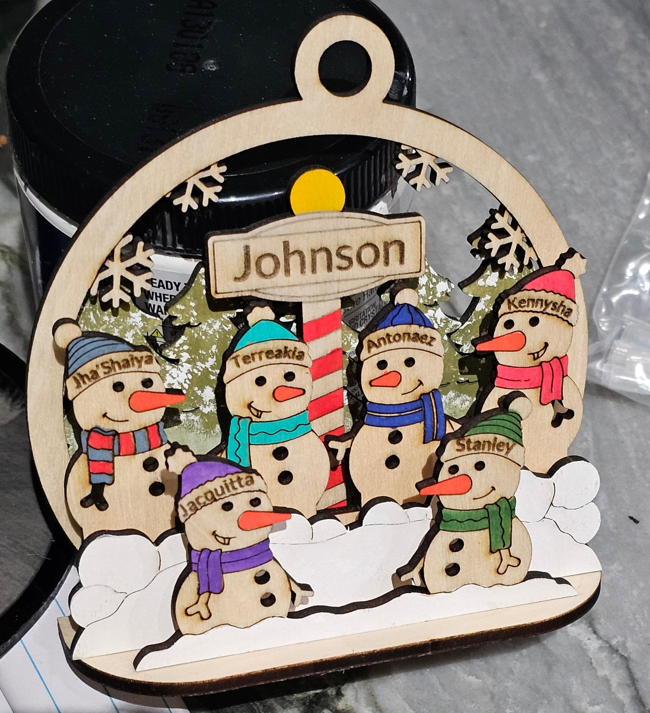 Personalized Snowman Family Christmas Ornament hanging on a tree