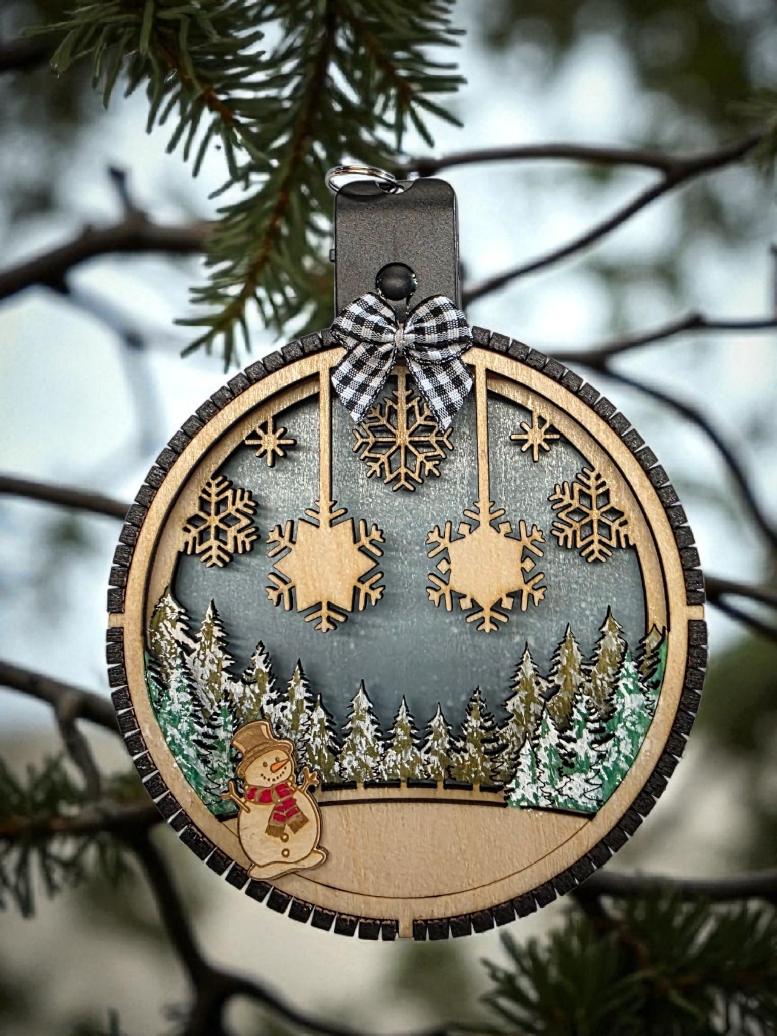 Personalized Lighted Snowflake Family Ornament hanging on a tree