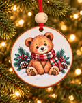 Teddy bear Christmas ornament with a bear in a plaid scarf sitting in snowy pines, 4 inch round wood Christmas ornament with 2026 bead by Bandit Laser