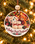 Baby's First Christmas ornament with knit baby booties and teddy bear by a lit tree, 4 inch round wood Christmas ornament with 2026 bead by Bandit Laser