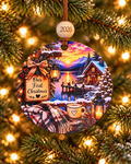 Our First Christmas couple's ornament with snowy lake cabin, lantern-lit dock and cocoa mug, 4 inch round wood Christmas ornament with 2026 bead by Bandit Laser