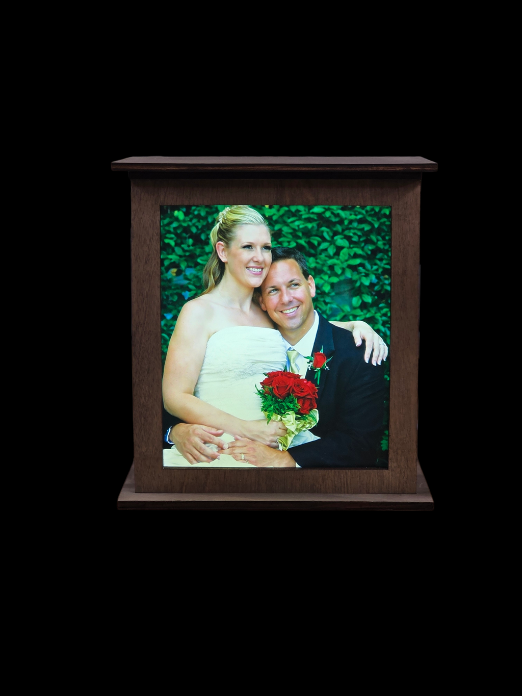 Wooden photo frame with a wedding photo of a couple on a black background