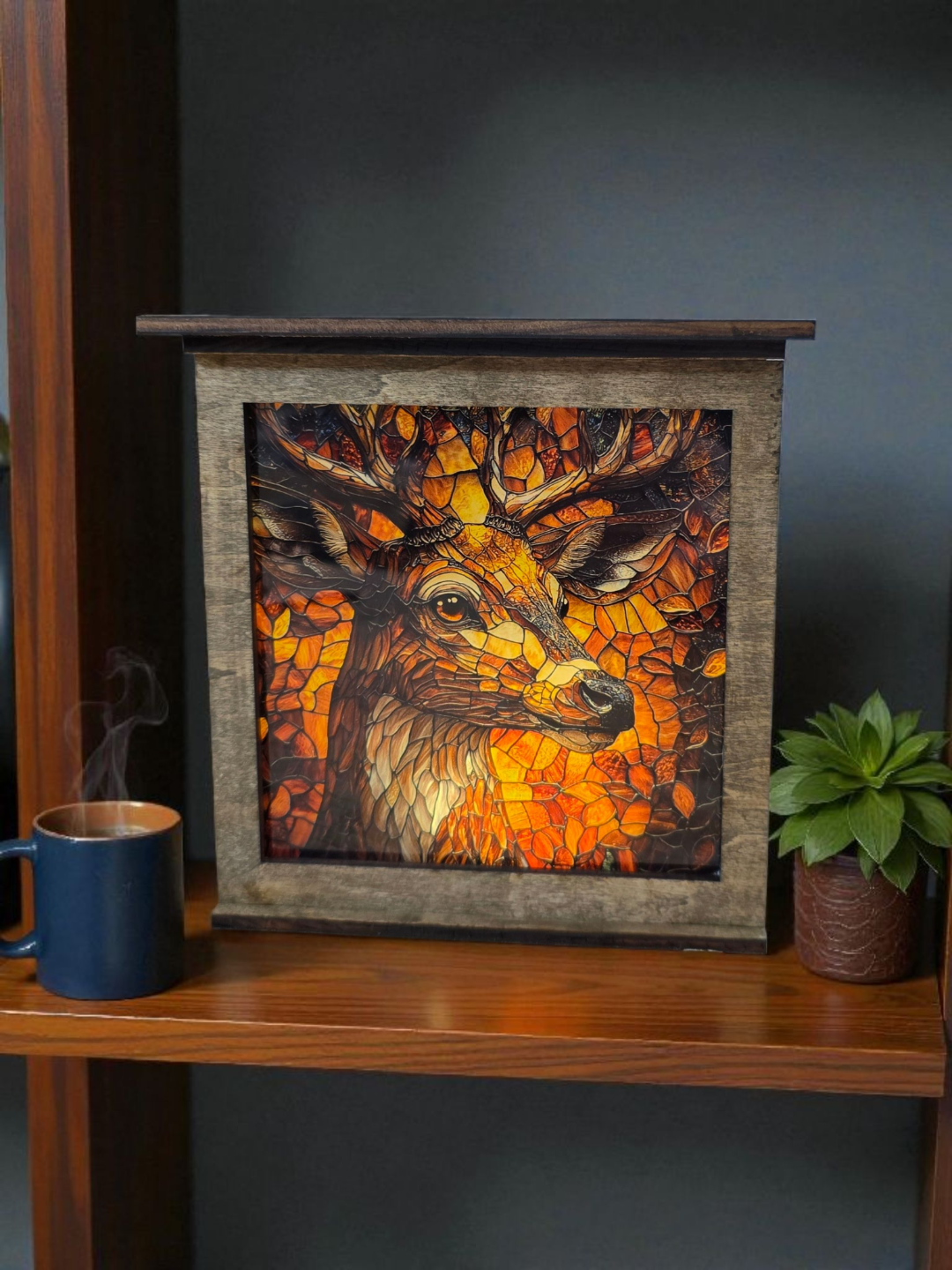 Framed mosaic artwork of a deer head on a wooden surface with a dark background