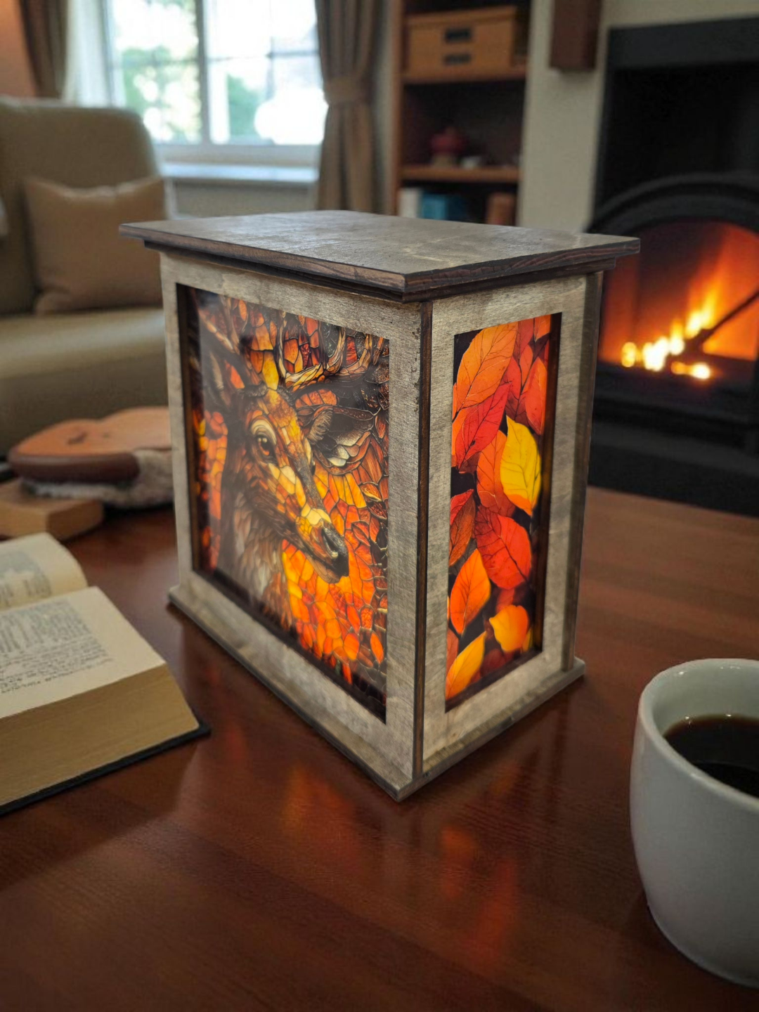 Decorative lantern with autumn leaf design on a table in a cozy room with a fireplace.