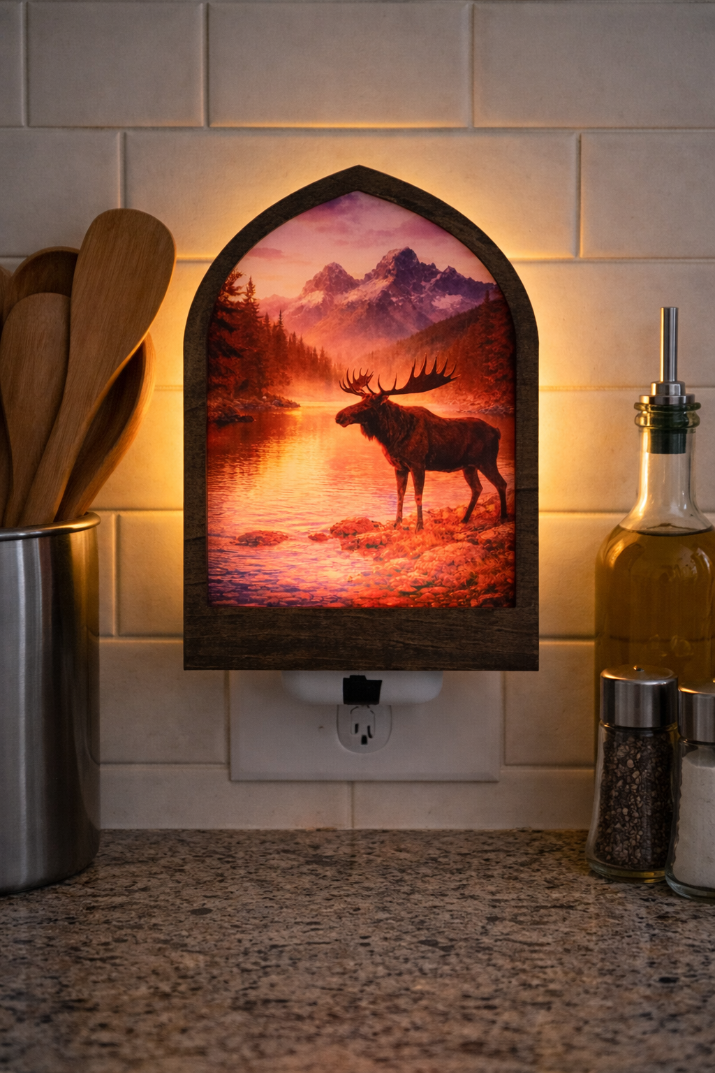 Decorative wall light with a moose design on a kitchen counter.