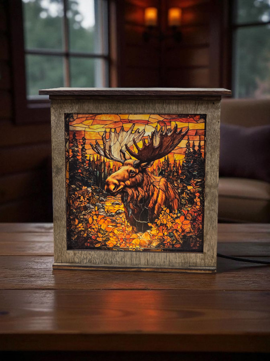 Decorative box with a moose design on a wooden surface