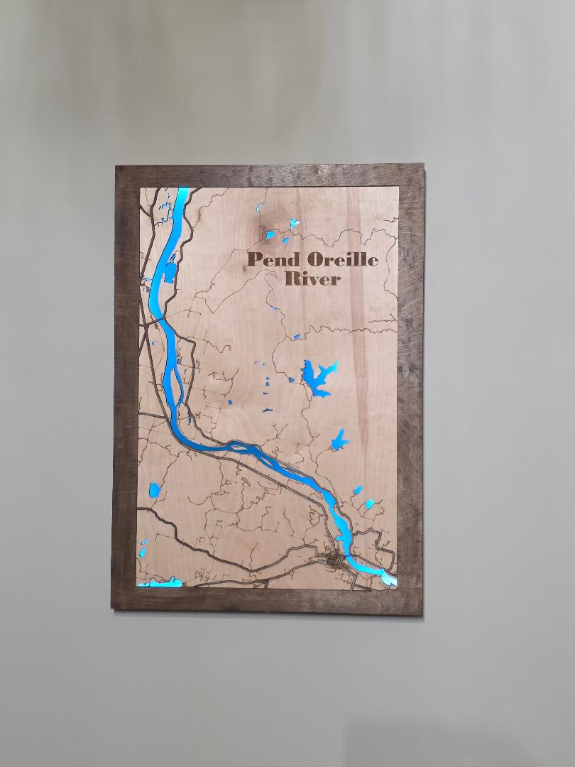 Wooden map of the Pend Oreille River with blue accents on a gray background