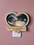 Heart-shaped night light with ultrasound image and text on a pink background